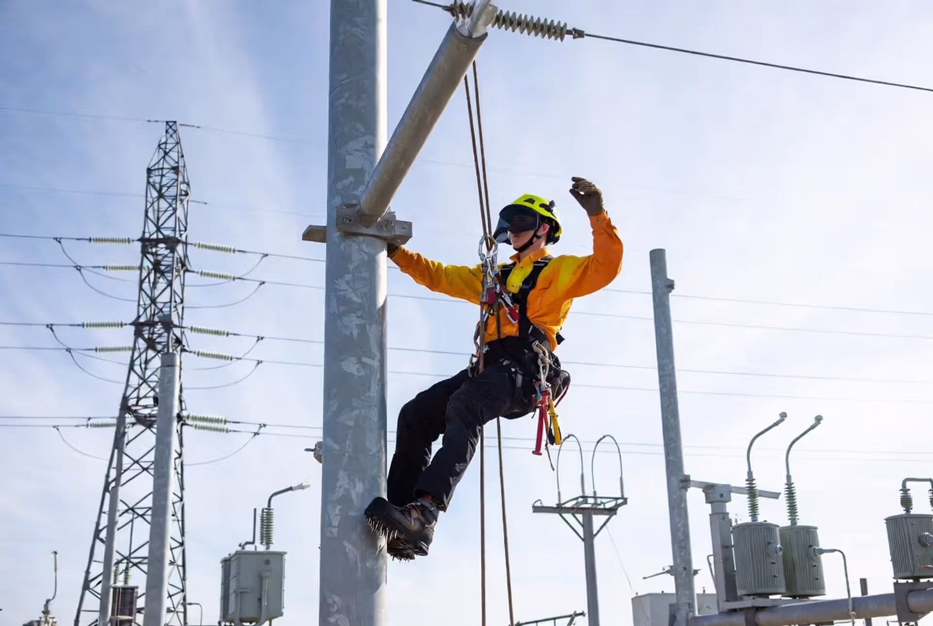 Aspiring lineman training on a utility pole at a dedicated lineman school program