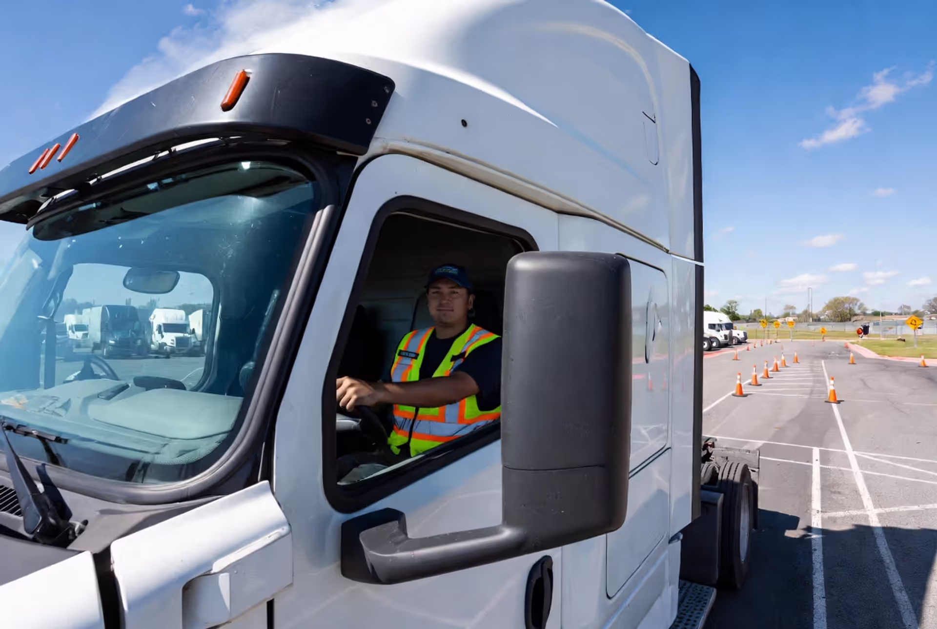 Aspiring truck driver behind the wheel during hands-on training at truck driving school